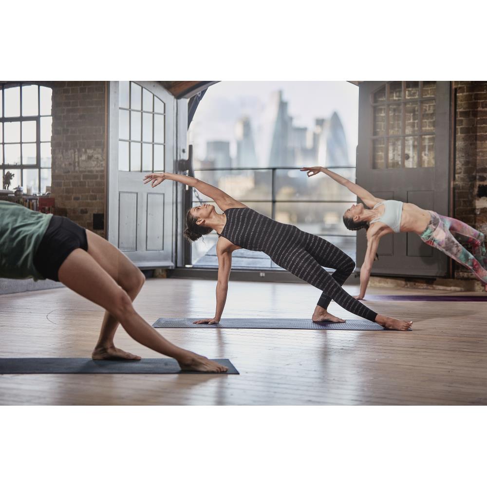 Yoga class doing a yoga pose on Reebok 4mm Yoga Mats - Brush Strokes