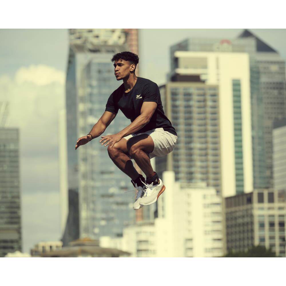 Man jumping whilst wearing Reebok Ankle Weights 