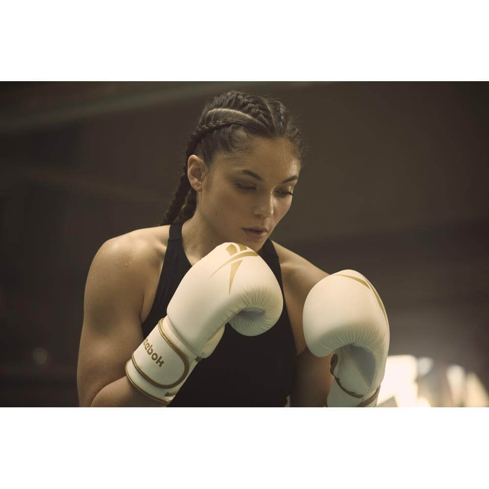 Woman wearing Reebok Boxing Gloves - White and Gold