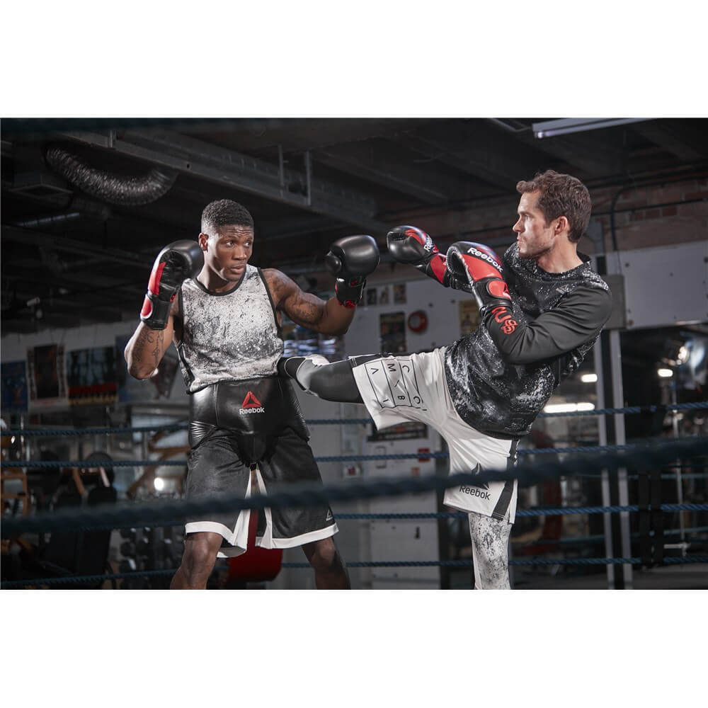 Two men in a boxing ring wearing Reebok Combat Leather Boxing Gloves - Kickboxing Training
