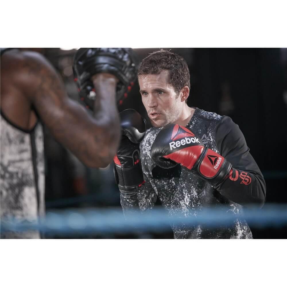 Reebok CombatTwo men in a boxing ring, one is wearing  Leather Boxing Gloves - Speed Training