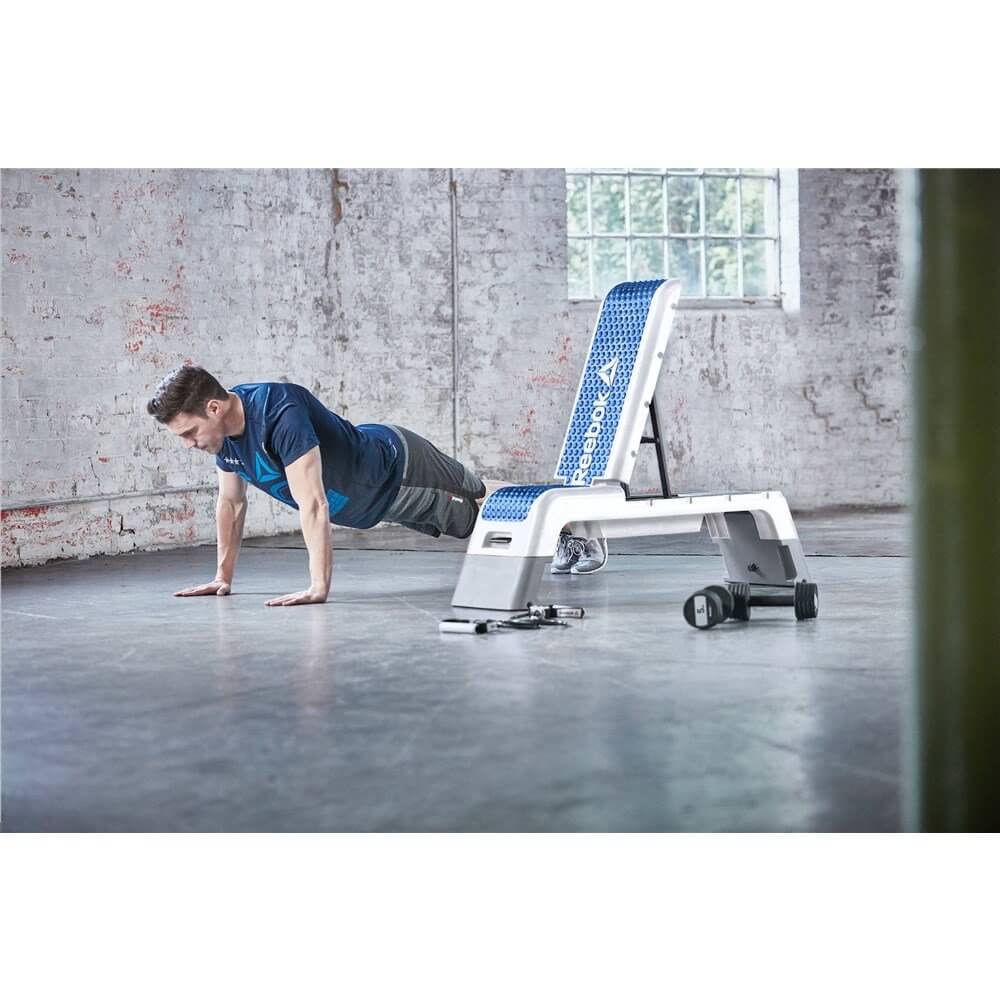 Man doing press ups next to a Reebok Deck - Gym Training