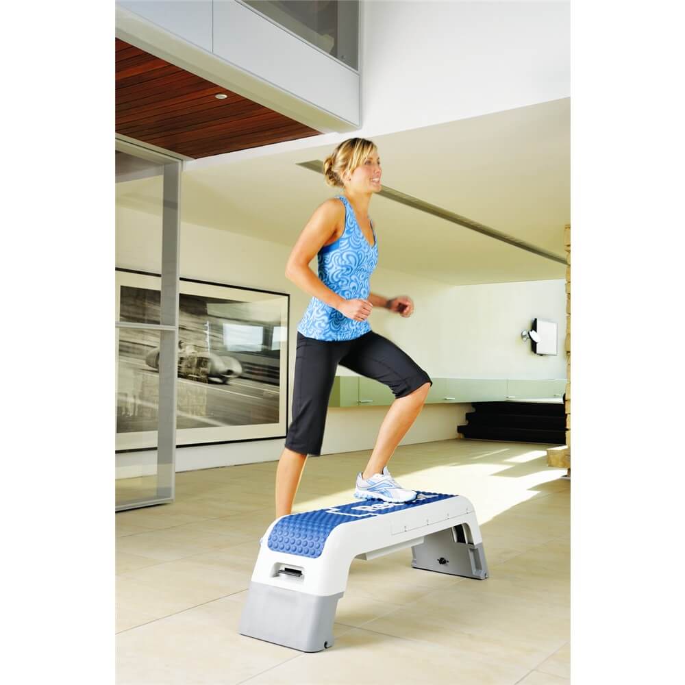 Woman at a Step class using a Reebok Deck 