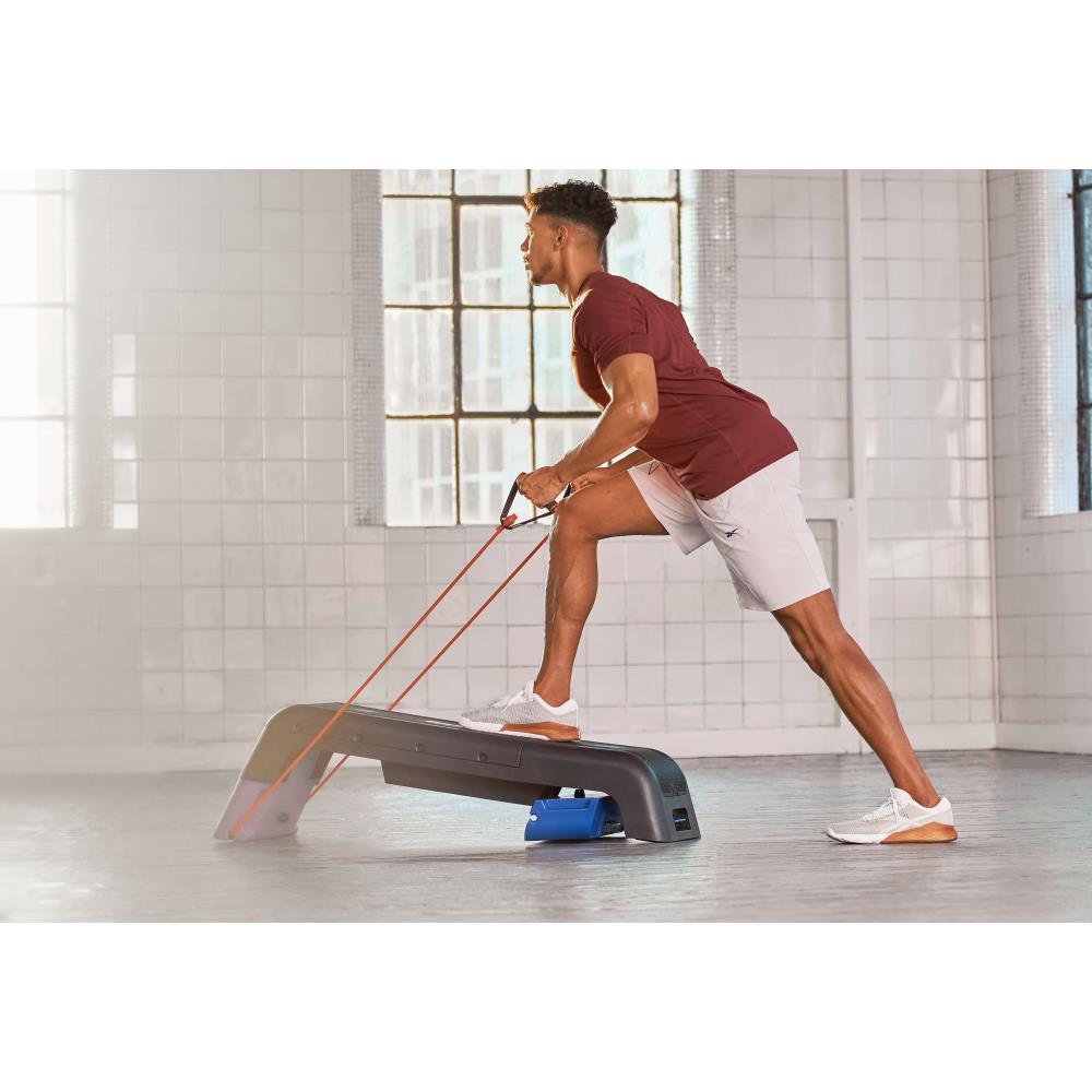 Man performing resistance training using a Reebok Deck Resistance Tube -  Blue