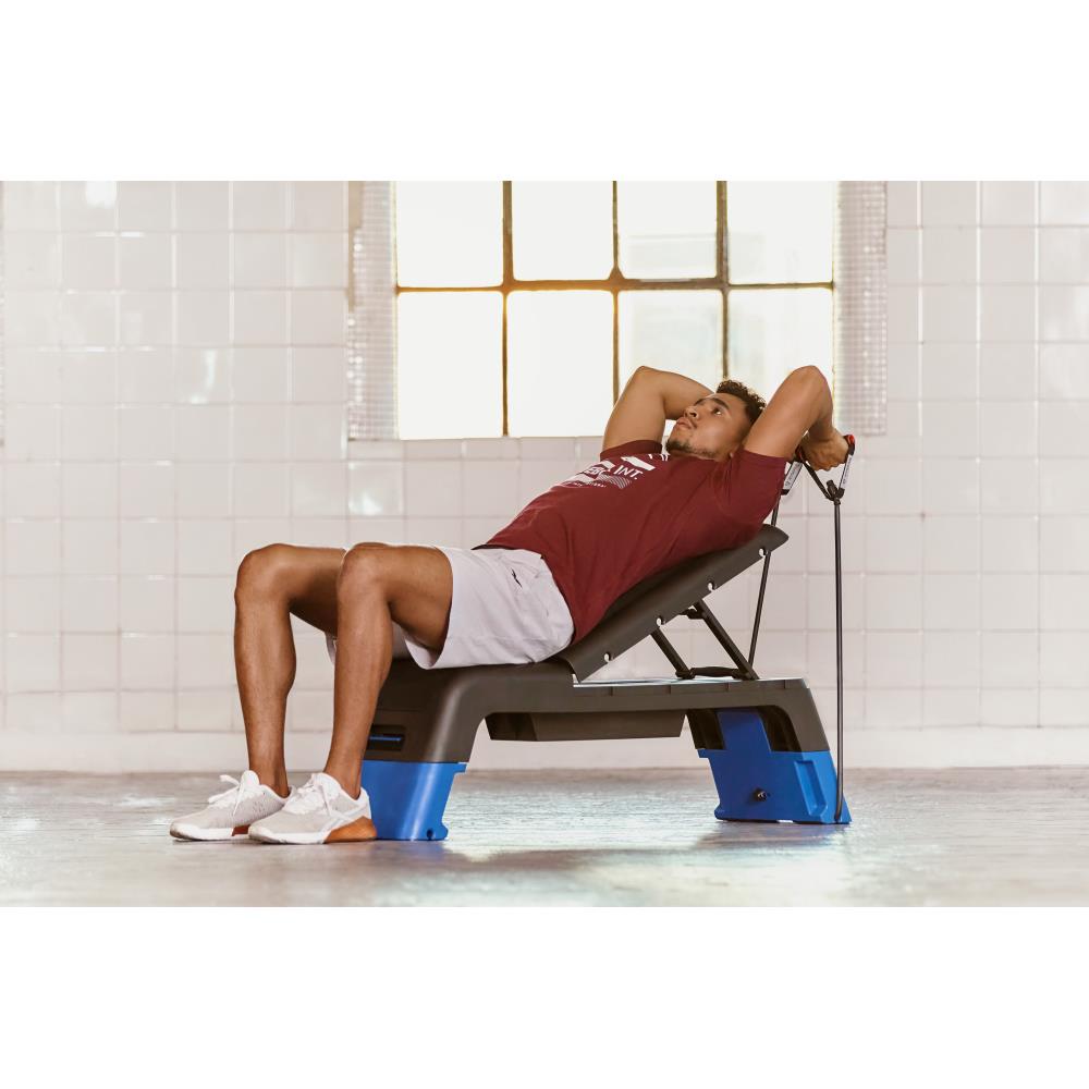 Man performing resistance training with resistance tubes on a Reebok Fitness Deck - Blue