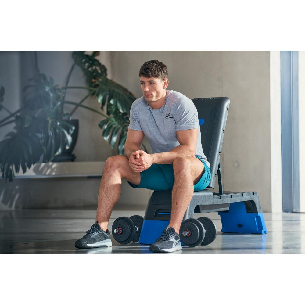 Man sitting on his Reebok Deck Blue - Home Gym