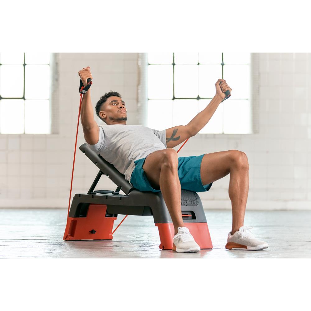 Man performing Reebok Deck Resistance Tube Workout - Red