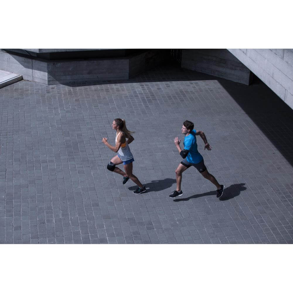 Two runners - One is wearing a Reebok Elbow Support
