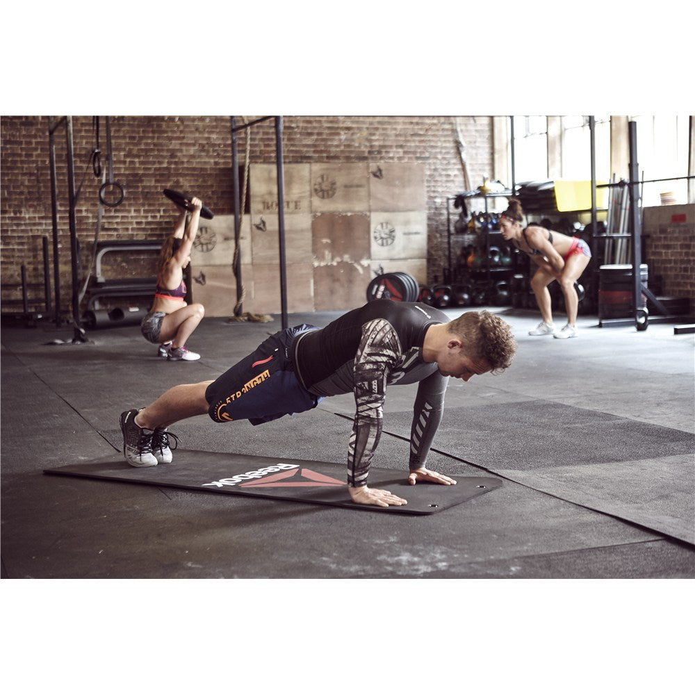 Man exercising in the gym on a Reebok Functional Workout Mat