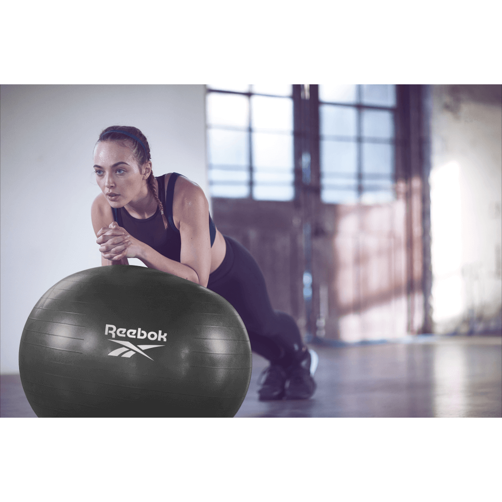 Woman performing a plank on Reebok 75cm Gym Ball - Black