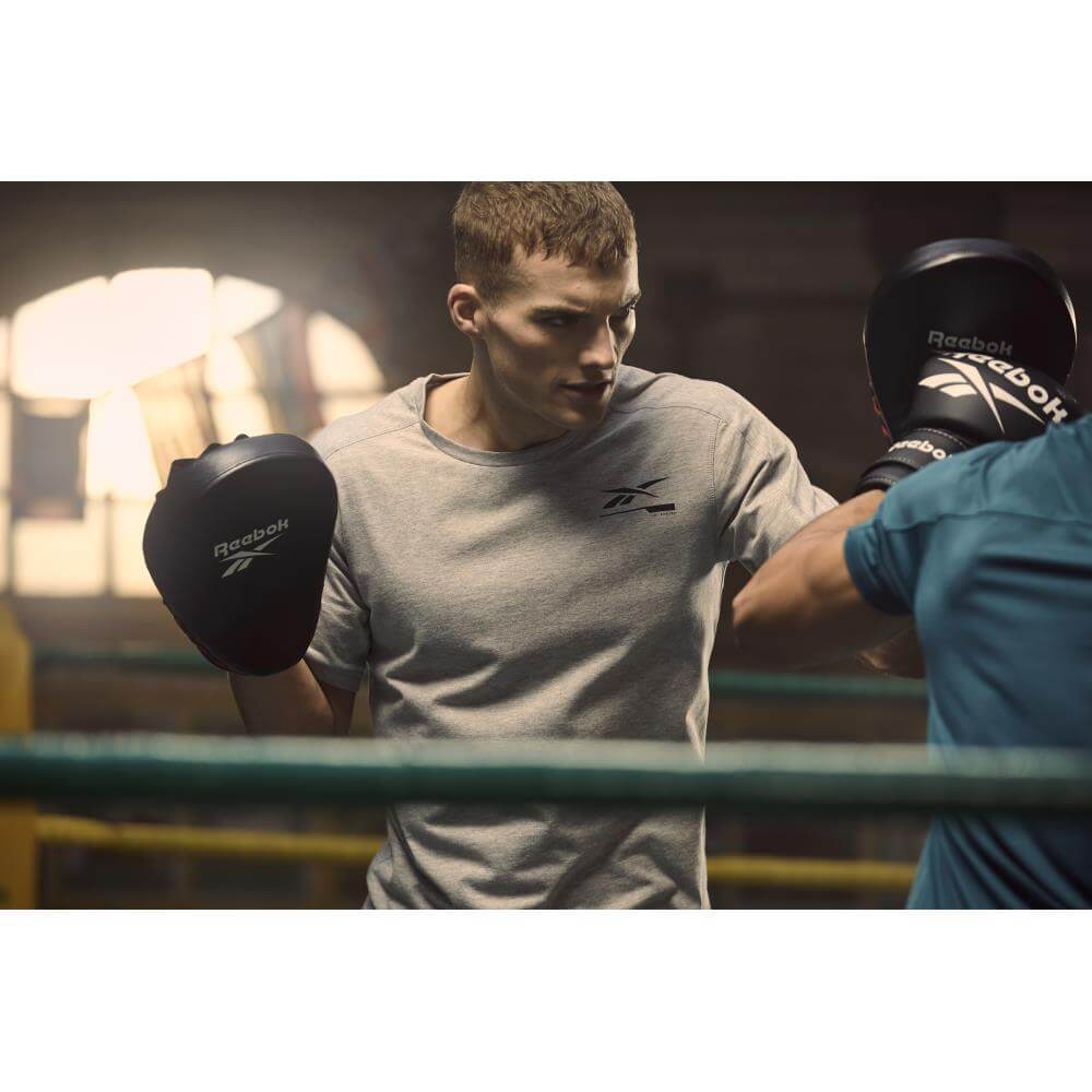 Men in boxing ring using Reebok Hook and Jab Pads