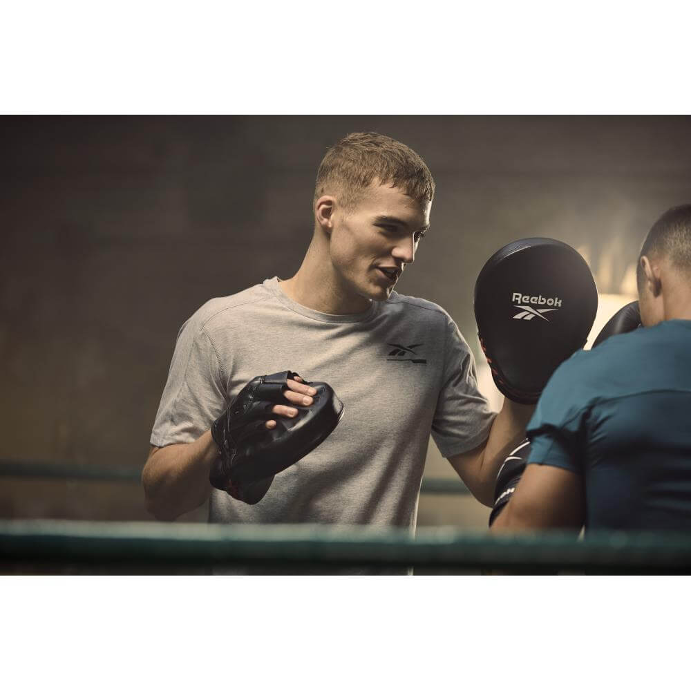 Men in boxing ring using Reebok Focus Pads