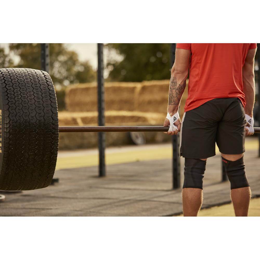 Man deadlifting whilst wearing Reebok Lifting Support Straps