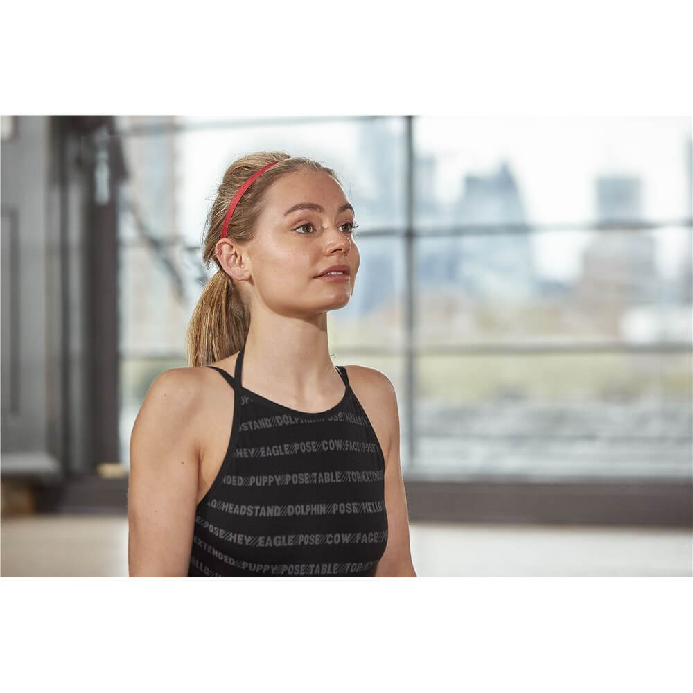 Woman in the gym wearing a red Reebok Sports Hair Band