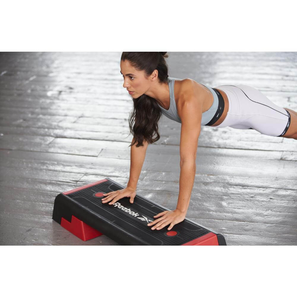 Woman performing a Reebok Step Home Workout - Red