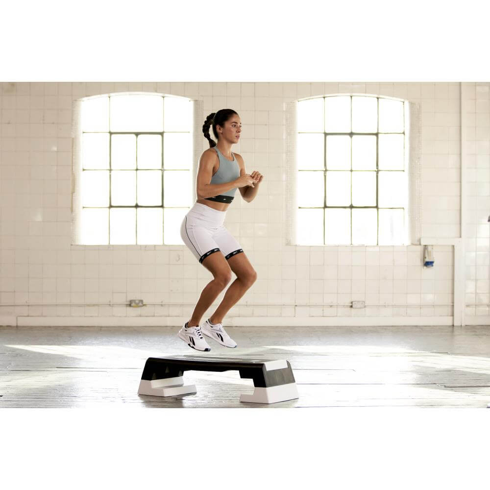 Woman performing a Reebok Step Home Workout - White