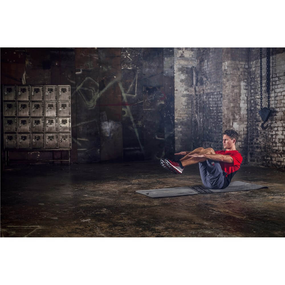 Man exercising in the gym on a Reebok Strength Fitness Mat - Grey