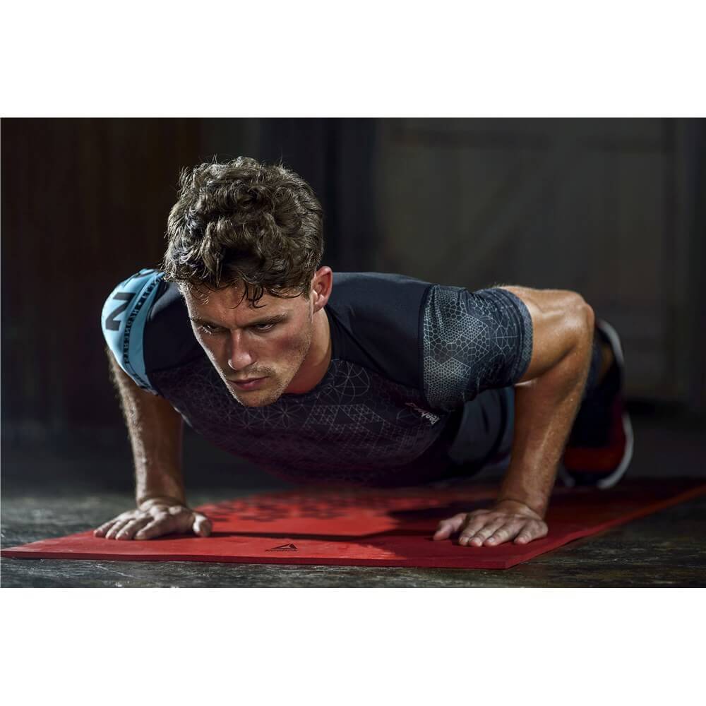 Man exercising on a Reebok Training Mat in the gym