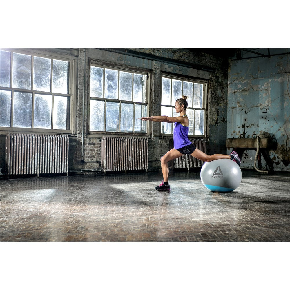 Woman exercising in the gym on a Reebok Womens Training Stability Gym Ball - 55cm