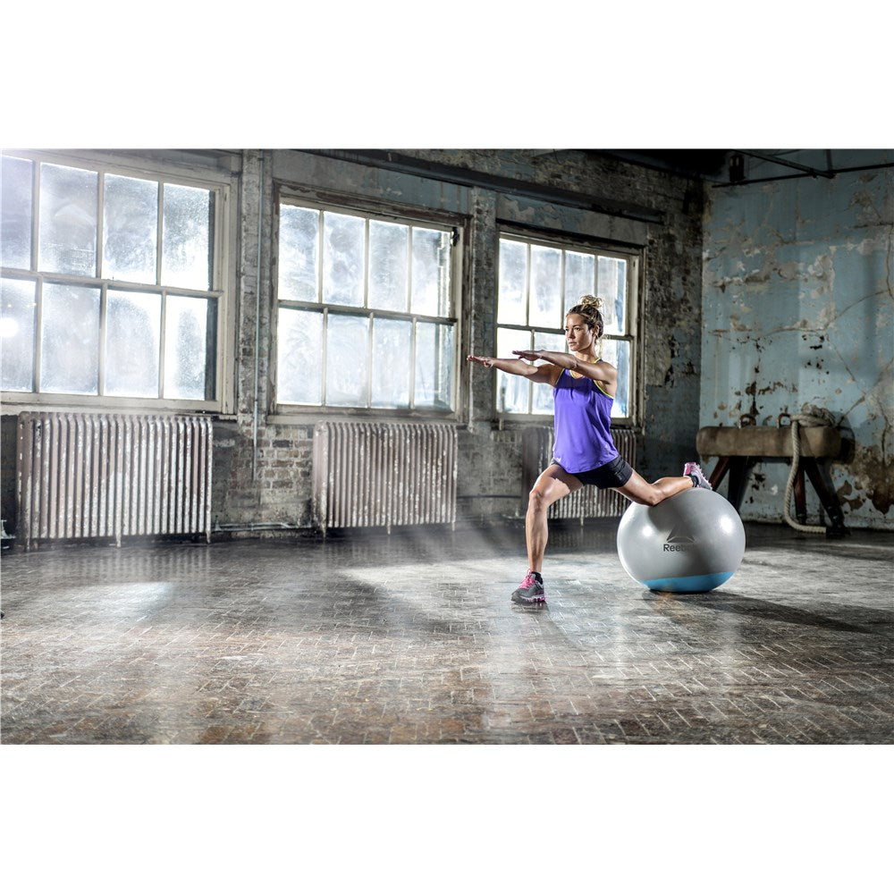 Woman exercising in the gym on a Reebok Womens Training Stability Gym Ball - 55cm