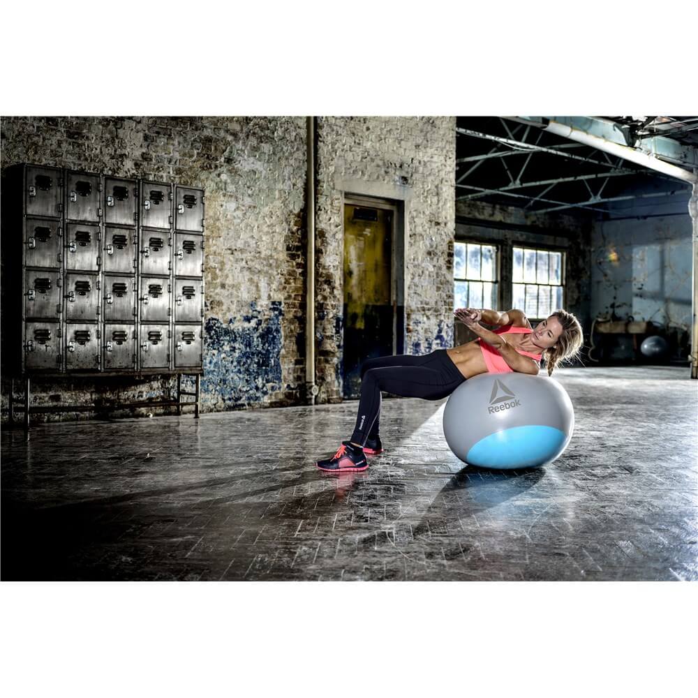 Woman exercising in the gym on a Reebok Womens Training Stability Gym Ball - 65cm