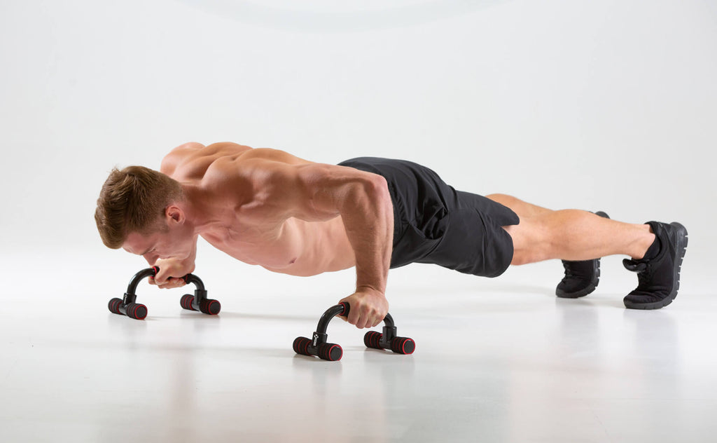 Man performing push ups using UXT Angled Parallels - Push Up Bars