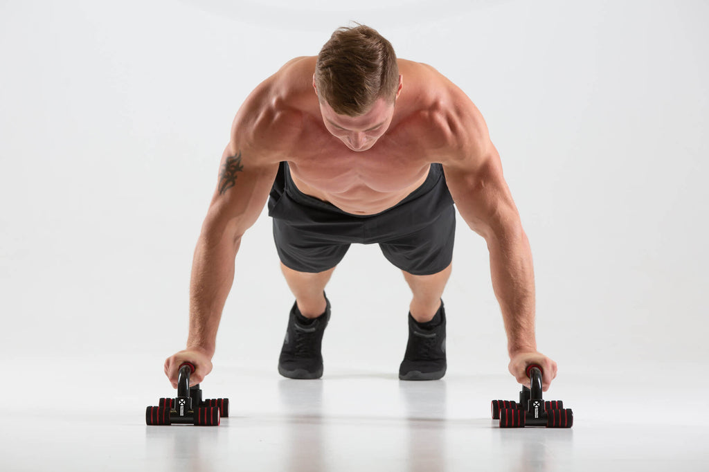 Man performing push ups using UXT Angled Parallels - Push Up Bars
