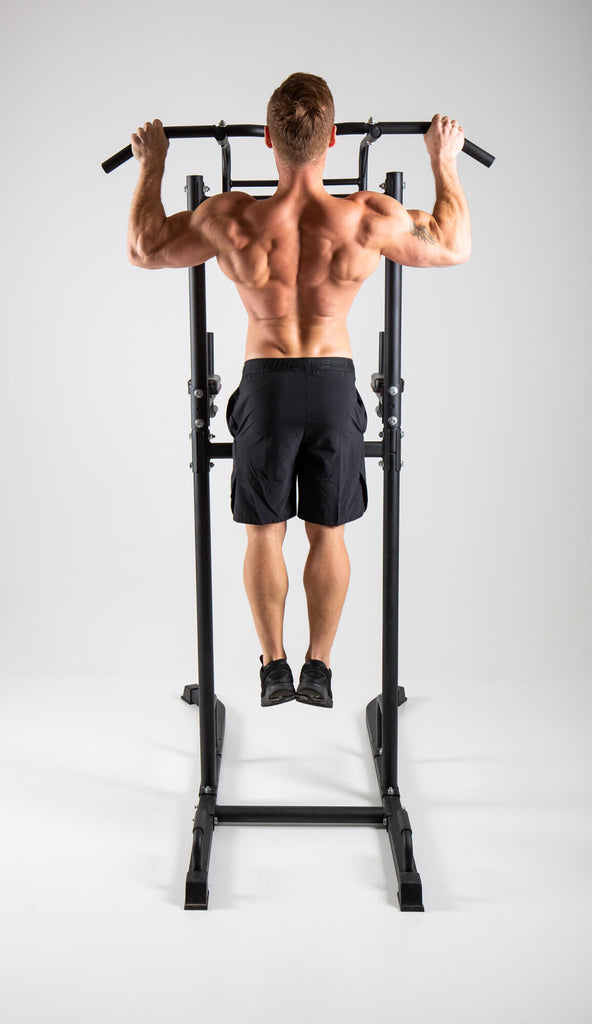 Man performing pull ups on a UXT Ultimate Power Tower