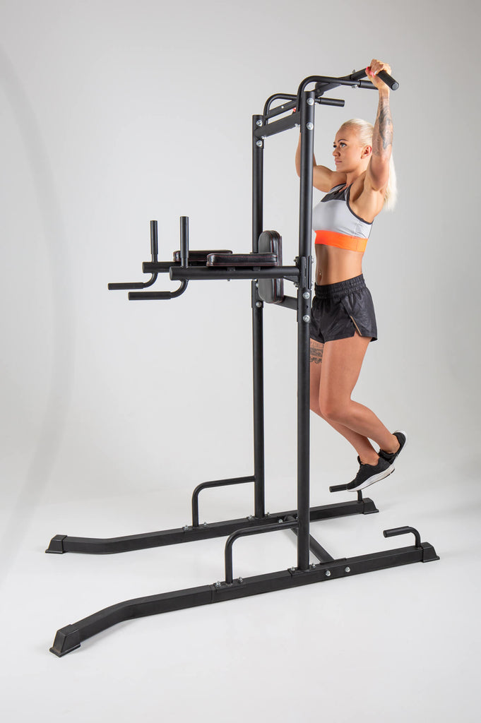Woman performing pull ups on a UXT Ultimate Power Tower