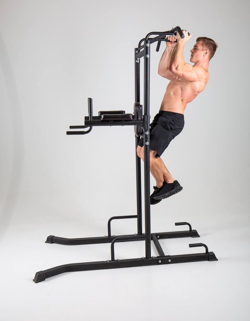 Man performing pull ups on a UXT Ultimate Power Tower