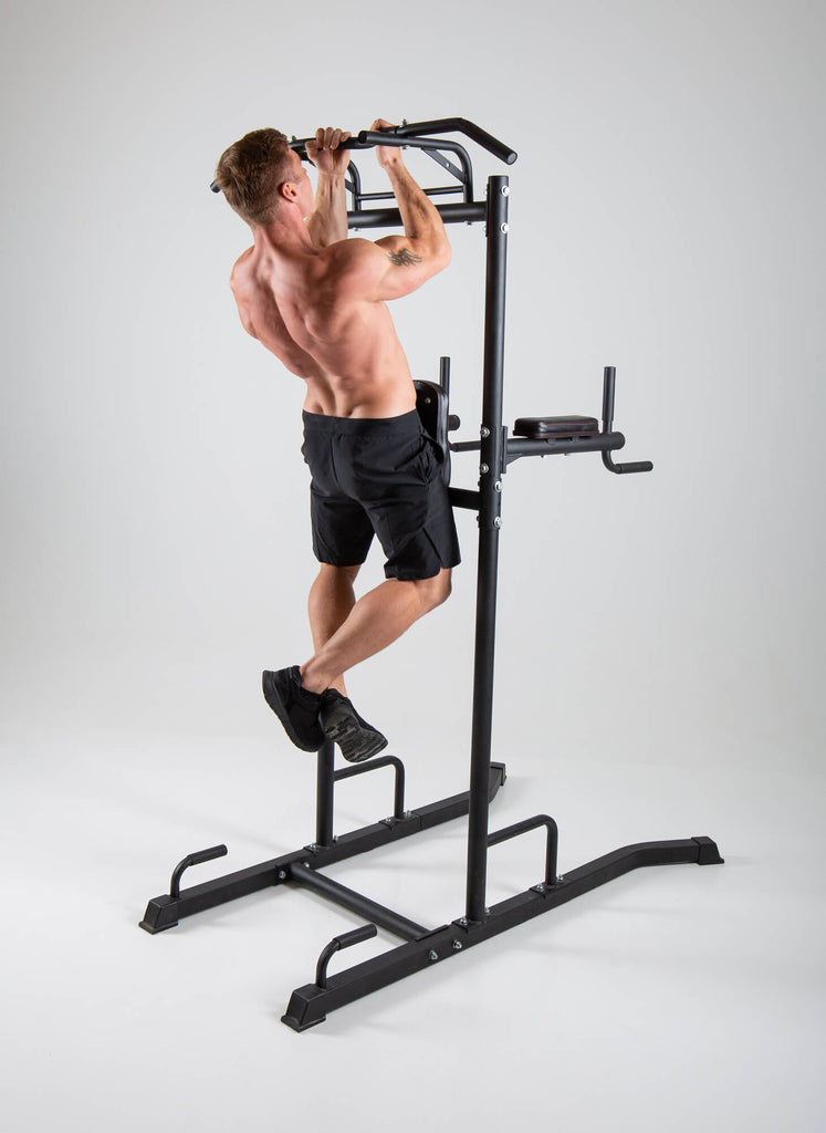 Man performing pull ups on a UXT Ultimate Power Tower