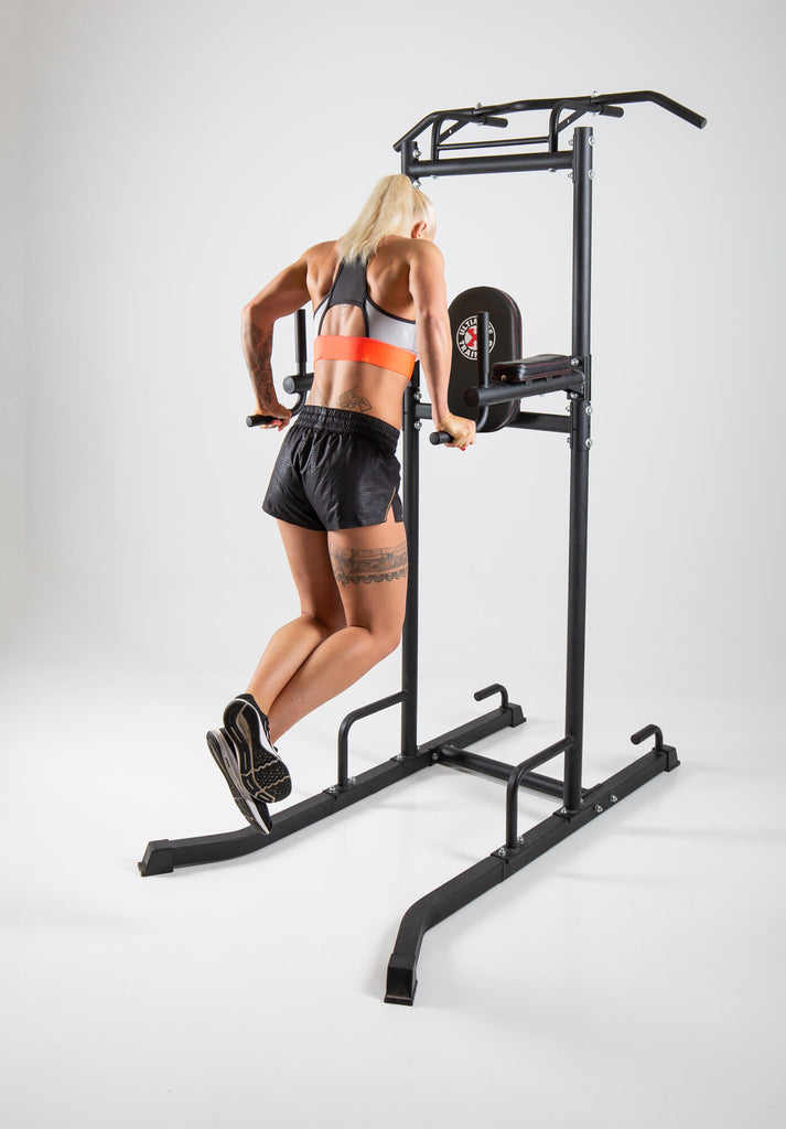 Woman performing dips on a UXT Ultimate Power Tower