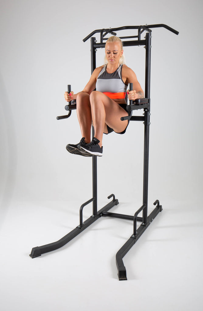 Woman exercising on a UXT Ultimate Power Tower