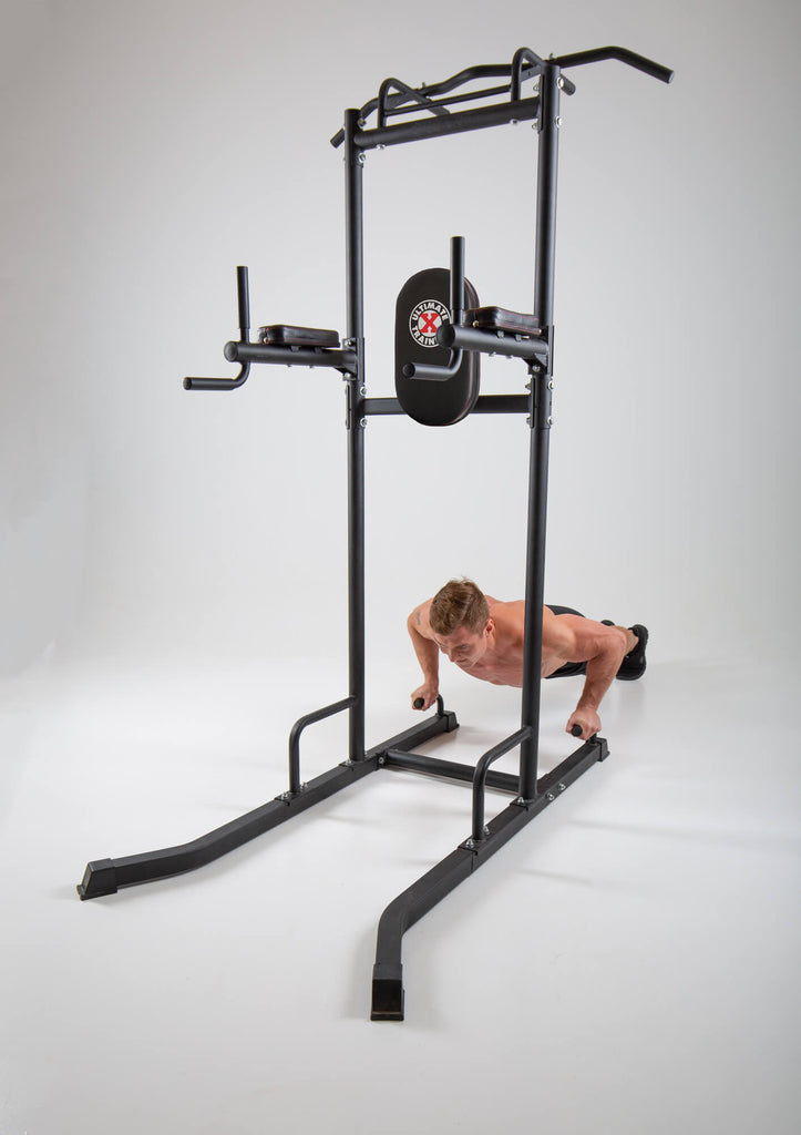 Man performing press ups on a UXT Ultimate Power Tower