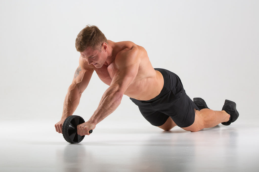 Man using a UXT Wide Ab Wheel with Pro-Grip Rubber Tread