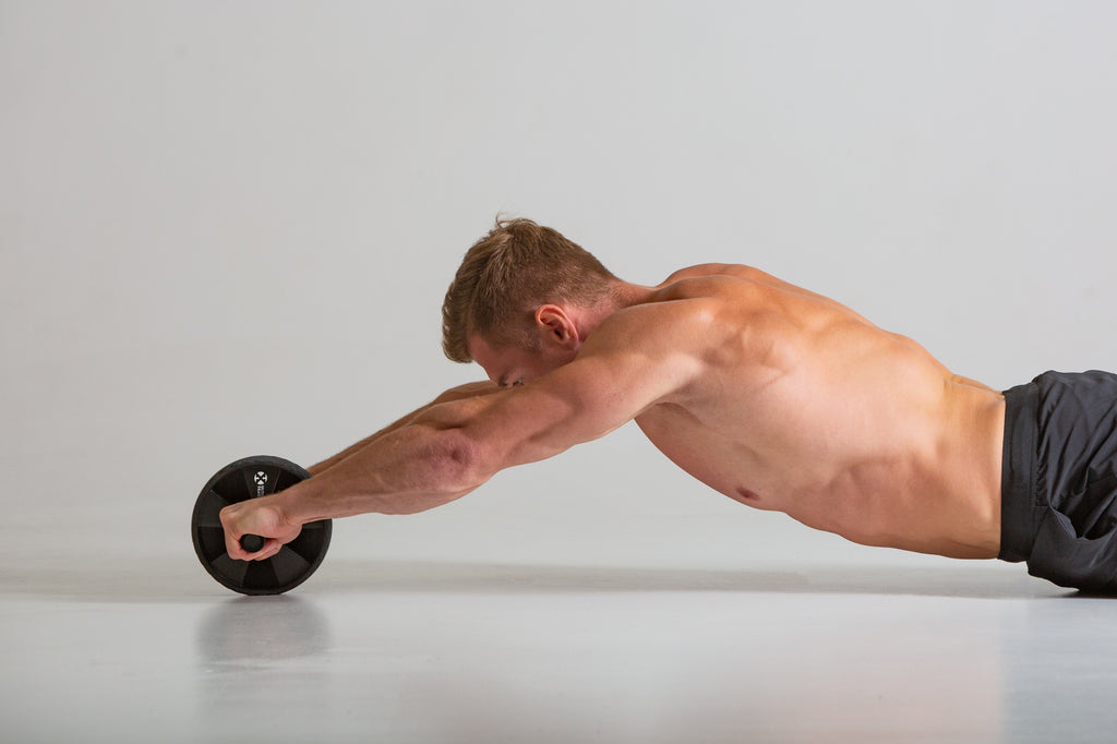 Man using a UXT Wide Ab Wheel with Pro-Grip Rubber Tread